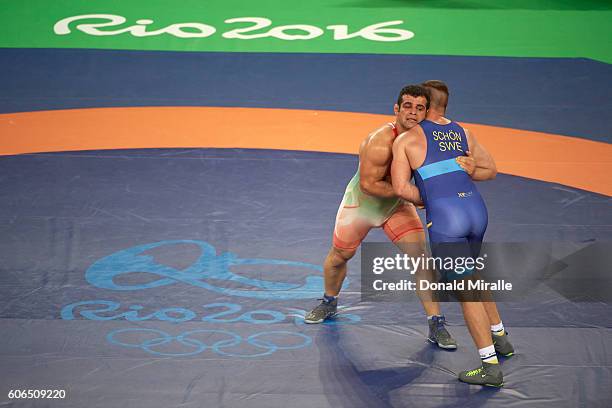 Summer Olympics: Iran Ghasem Rezaei in action, defeating Sweden Fredrik Schon duirng Men's Greco-Roman 98 kg Bronze Medal Semifinal at Carioca Arena....