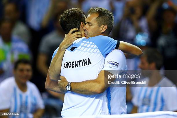 Guido Pella of Argentina is congratulated by Argentina team captain, Daniel Orsanic following his victory in his singles match against Kyle Edmund of...