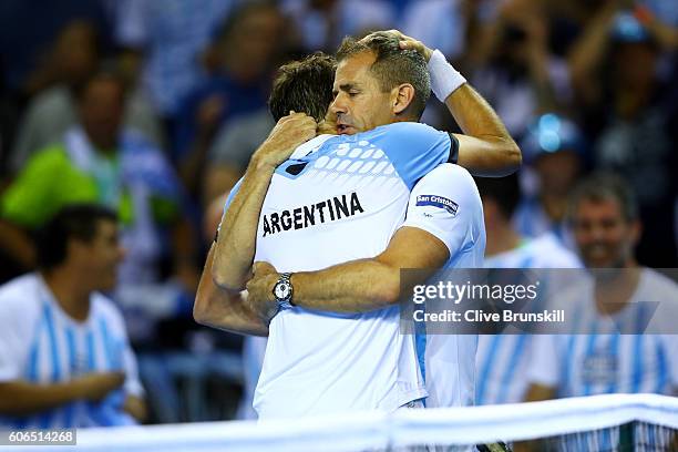 Guido Pella of Argentina is congratulated by Argentina team captain, Daniel Orsanic following his victory in his singles match against Kyle Edmund of...