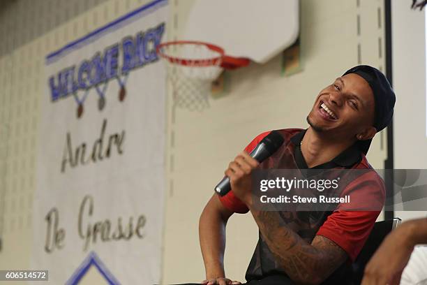 Andre De Grasse laughs as a student challenges him to a game of one-on-one. Olympic triple sprint medalist, Andre De Grasse returns his alma mater,...
