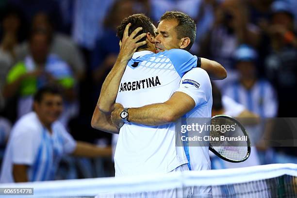 Guido Pella of Argentina is congratulated by Argentina team captain, Daniel Orsanic following his victory in his singles match against Kyle Edmund of...