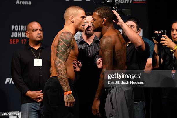 Dustin Poirier of the United States and Michael Johnson of the United States face off during the UFC Fight Night weigh-in at the State Farm Arena on...