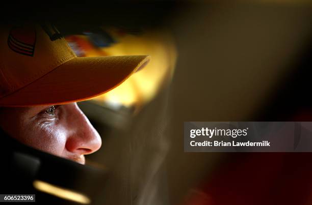 Chris Buescher, driver of the Love's Travel Stops Ford, sits in his car during practice for the NASCAR Sprint Cup Series Teenage Mutant Ninja Turtles...