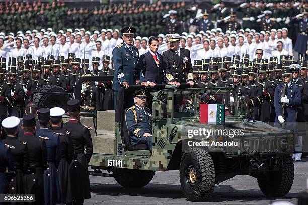 President of Mexico Enrique Pena Nieto flanked by Defense Secretary Salvador Cienfuegos Zepeda and Admiral Vidal Francisco Soberon Sanz review the...