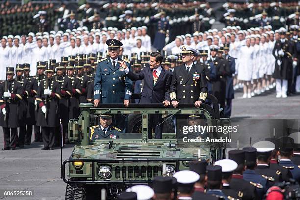 President of Mexico Enrique Pena Nieto flanked by Defense Secretary Salvador Cienfuegos Zepeda and Admiral Vidal Francisco Soberon Sanz review the...