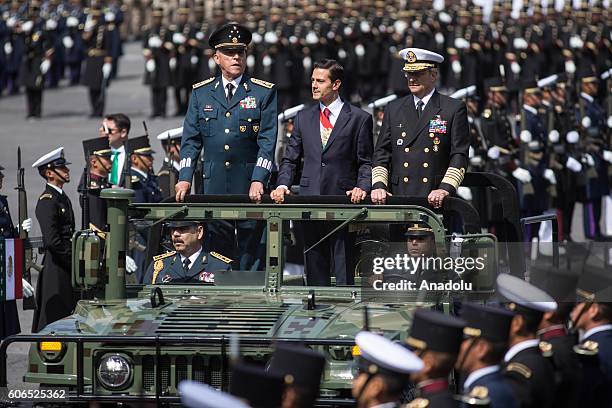 President of Mexico Enrique Pena Nieto flanked by Defense Secretary Salvador Cienfuegos Zepeda and Admiral Vidal Francisco Soberon Sanz review the...