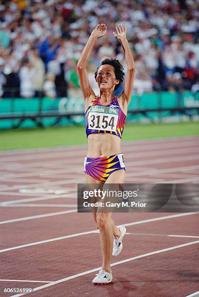 Chinese long-distance runner Wang Junxia celebrates after winning the Women's 5000 metres event on 2nd August 1996 during the XXVI Summer Olympic...