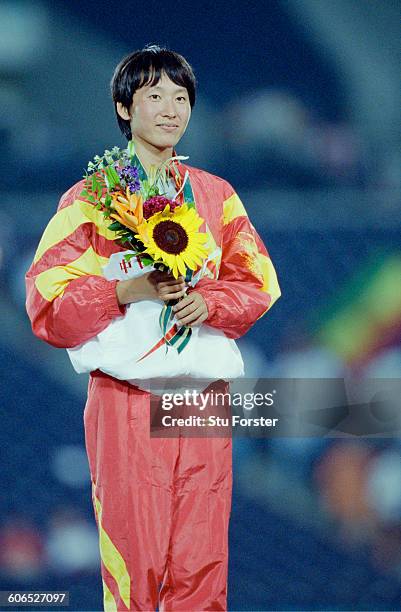 Chinese long-distance runner Wang Junxia on the podium after taking the silver medal in the Women's 10,000 metres event 2nd August 1996 during the...