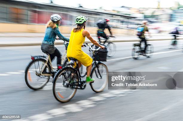 bicyclists in traffic - cycling helmet stock pictures, royalty-free photos & images
