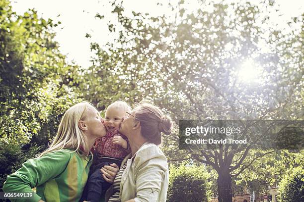 lesbian family with baby boy - lesbians stock-fotos und bilder