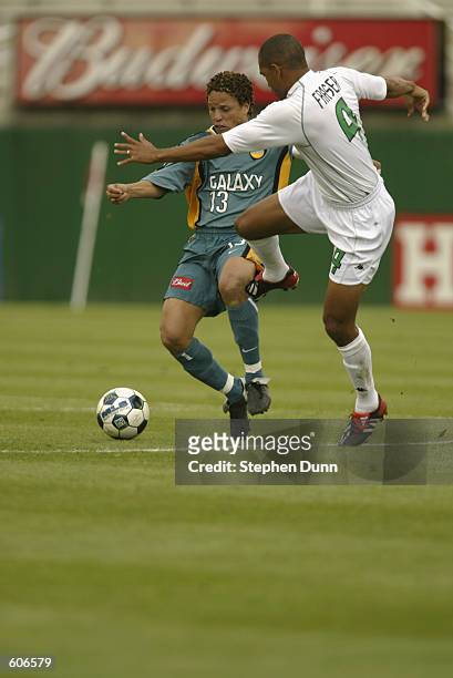 Cobi Jones of the Los Angeles Galaxy contends for the ball with Robin Fraser of the Colorado Rapids in their MLS game at the Rose Bowl in Pasadena,...