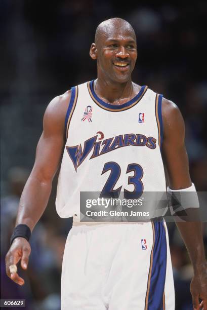 Guard Michael Jordan of the Washington Wizards walks down the court and smiles during the NBA game against the Milwaukee Bucks at the MCI Center in...