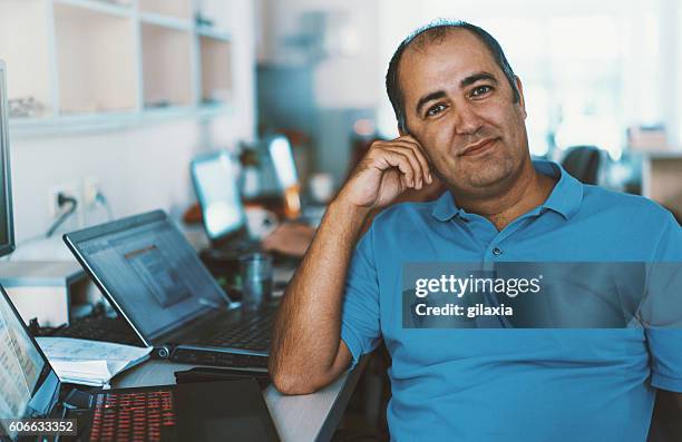 senior developer at work. - man with polo shirt stock pictures, royalty-free photos & images