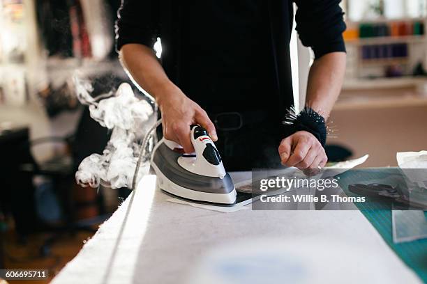 fashion designer steaming a pattern - steam ironing bildbanksfoton och bilder