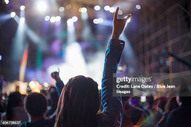 happy young woman at music festival - horn sign stock pictures, royalty-free photos & images