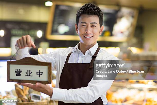 Shopkeeper Open Sign Photos and Premium High Res Pictures - Getty Images
