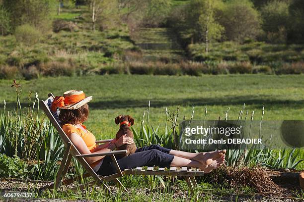 young woman resting in deckchair - haute vienne stock pictures, royalty-free photos & images
