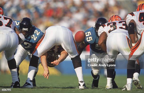 Center Brad St. Louis of the Cincinnati Bengals hiking the ball during the game against the Jacksonville Jaguars at the Alltel Stadium in...