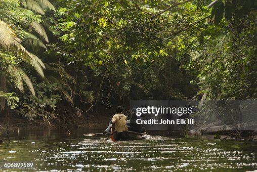 Pirogue exploring Amazon rainforest Pirogue exploring Amazon rainforest