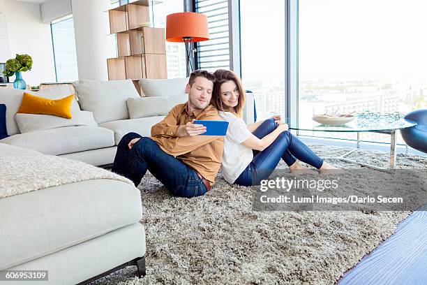 couple relaxing in modern apartment - dario secen stock-fotos und bilder