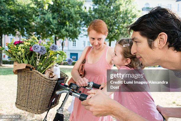 family with two children and bicycle - alexandra dost stockfoto's en -beelden