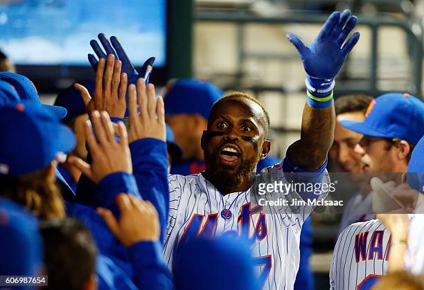 Jose Reyes of the New York Mets celebrates his third inning home run against the Minnesota Twins with his teammates in the dugout at Citi Field on...