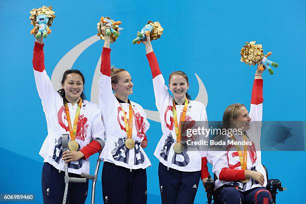 Gold medalists Alice Tai, Claire Cashmore, Stephanie Slater and Stephanie Millward of Great Britain celebrate on the podium at the medal ceremony for...