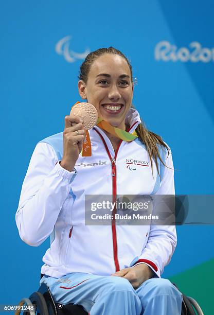 Bronze medalist Sarah Louise Rung of Norway celebrates on the podium at the medal ceremony for the Women's 50m Backstroke - S5 on day 9 of the Rio...