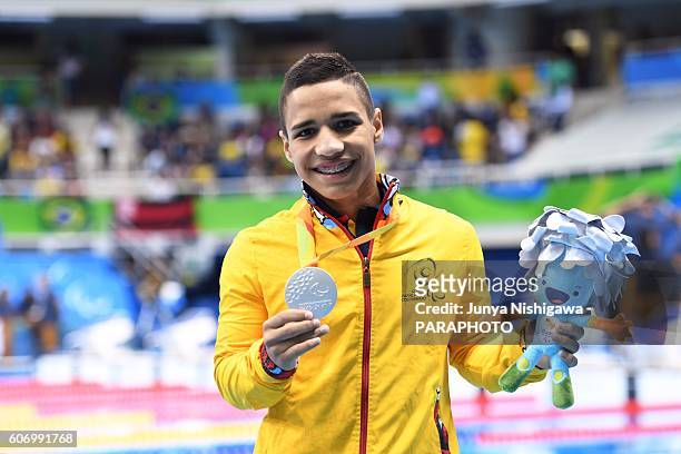 Silver medalist Carlos Serrano Zarate of Colombia celebrates on the podium at the medal ceremony for the Men's 100m Freestyle - S7 Final on day 9 of...