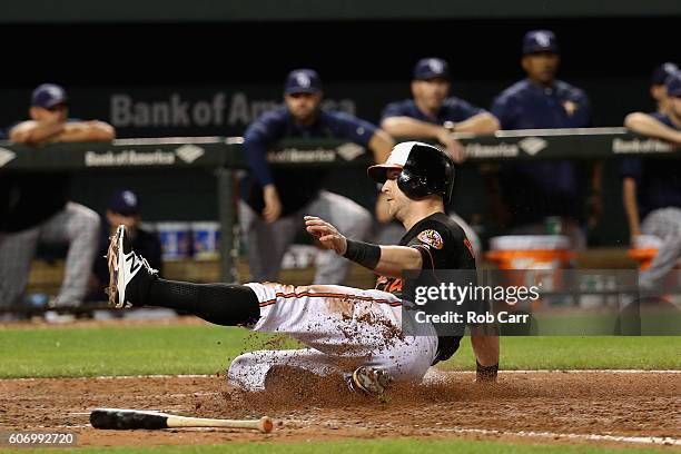 Nolan Reimold of the Baltimore Orioles scores a run in the eighth inning of the Orioles 5-4 win over the Tampa Bay Rays at Oriole Park at Camden...