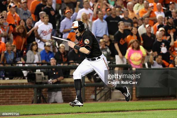 Nolan Reimold of the Baltimore Orioles runs to home plate to score a run in the eighth inning of the Orioles 5-4 win over the Tampa Bay Rays at...