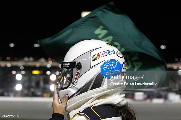 Official wears a sticker in memory of Betty Jane France during the NASCAR Camping World Truck Series American Ethanol E15 225 at Chicagoland Speedway...