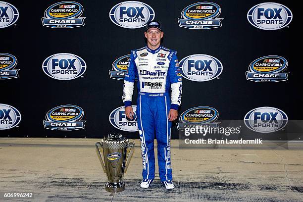 Daniel Hemric, driver of the Draw-Tite Ford, poses with the NASCAR Camping World Truck Series trophy after the NASCAR Camping World Truck Series...