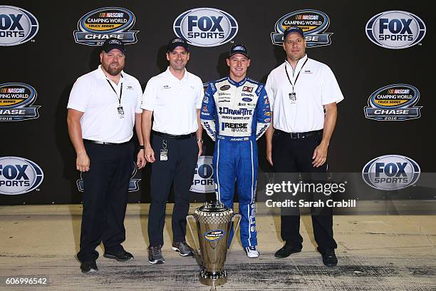 Daniel Hemric, driver of the Draw-Tite Ford, and Ford executives pose with the NASCAR Camping World Truck Series trophy after the NASCAR Camping...