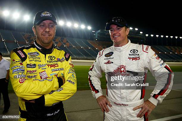 Matt Crafton, driver of the Fisher Nuts/Menards Toyota, and Timothy Peters, driver of the Red Horse Racing Toyota, stand on the grid after the NASCAR...