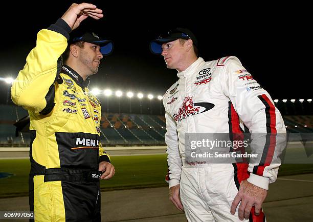 Matt Crafton, driver of the Fisher Nuts/Menards Toyota, and Timothy Peters, driver of the Red Horse Racing Toyota, talk on pit road after the NASCAR...