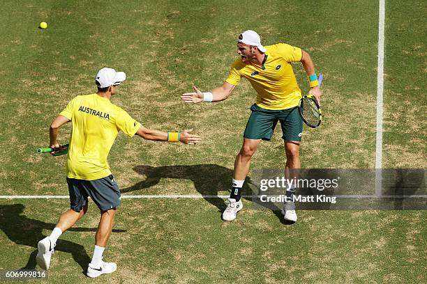 John Peers and Sam Groth of Australia celebrate winning the first set in the doubles match against Andrej Martin and Igor Zelenay of Slovakia during...