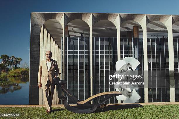 Brazilian architect Oscar Niemeyer poses outside the Mondadori headquarters in Segrate, a comune in Milan, Italy, circa 1975. He is responsible for...