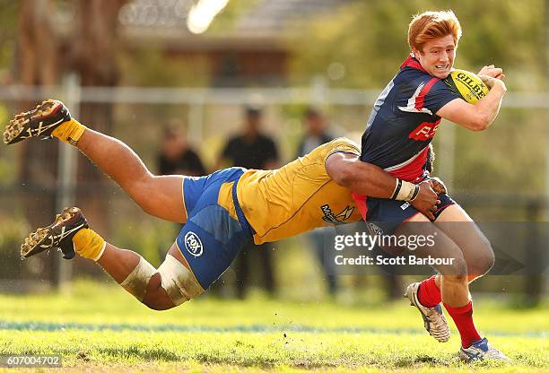 Nic Stirzaker of the Rising is tackled by Criff Tupou of City during the round four NRC match between Melbourne Rising and Brisbane City at...