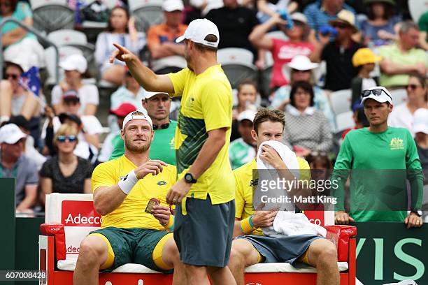 Captain of Australian Lleyton Hewitt talks to Sam Groth and John Peers of Australia during the doubles match against Andrej Martin and Igor Zelenay...