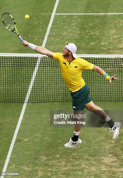 Sam Groth of Australia volleys playing with John Peers in the doubles match against Andrej Martin and Igor Zelenay of Slovakia during the Davis Cup...