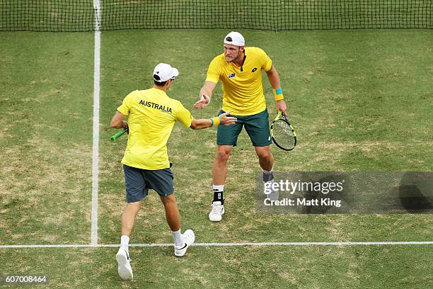 John Peers and Sam Groth of Australia celebrate winning a point in the doubles match against Andrej Martin and Igor Zelenay of Slovakia during the...