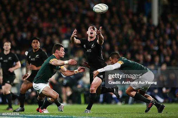 Ryan Crotty of New Zealand knocks the ball on while being tackled by Jesse Kriel of South Africa during the Rugby Championship match between the New...