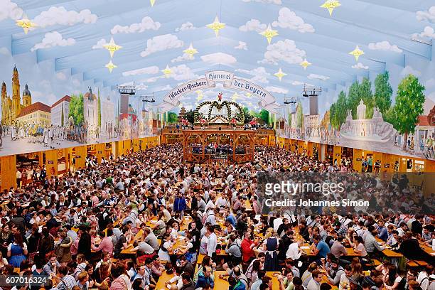 Visitors wait for the kick off the 2016 Oktoberfest beer festival in the Hacker-Pschorr tent at Theresienwiese on September 17, 2016 in Munich,...