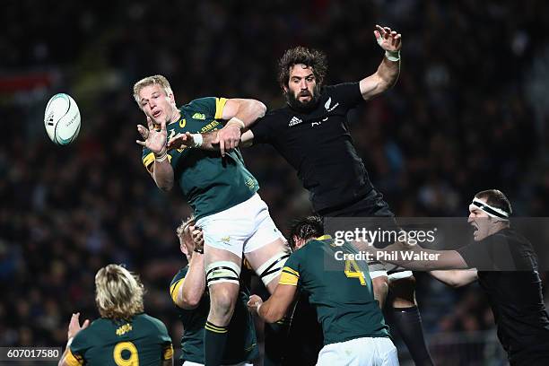 Pieter-Steph Du Toit of South Africa clears the ball from the lineout under pressure from Sam Whitelock of the All Blacks during the Rugby...