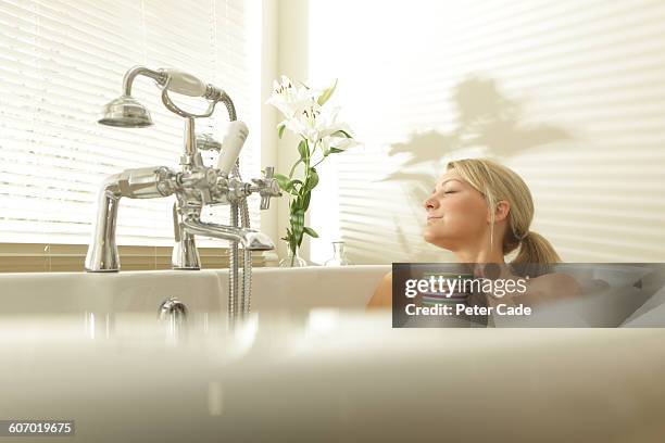 woman relaxing in bath with drink - domestic bathroom stock pictures, royalty-free photos & images