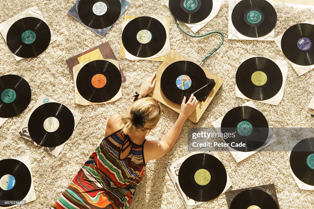 Woman on floor playing records