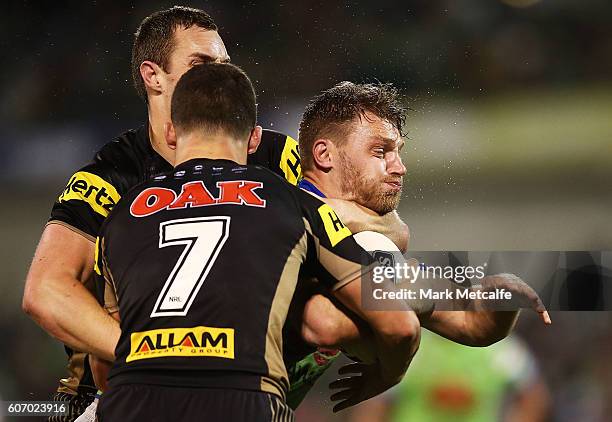 Elliott Whitehead of the Raiders is tackled during the second NRL Semi Final match between the Canberra Raiders and the Penrith Panthers at GIO...