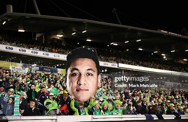 Raiders fan holds up a giant face of Josh Papalii of the Raiders during the second NRL Semi Final match between the Canberra Raiders and the Penrith...