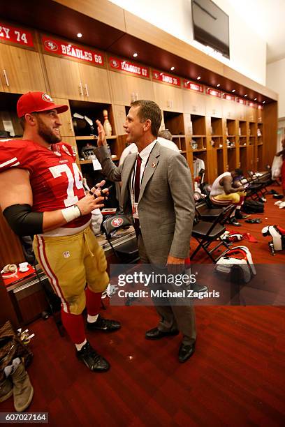 Joe Staley and General Manager Trent Baalke of the San Francisco 49ers talk in the locker room following the game against the Los Angeles Rams at...